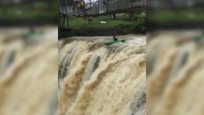 WATCH: Nutcase Kayaks Over Flood-Swollen QLD Waterfall & Survives Like NBD
