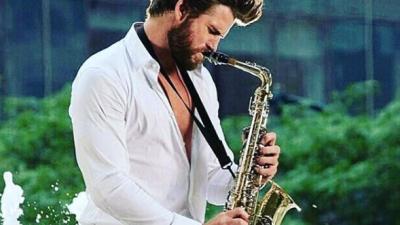Behold Liam Hemsworth Crushing The Sax In New Musical Romcom 