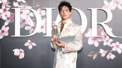 Ezra Miller’s Latest Look Is Pretend Note-Taking With A Champagne Glass