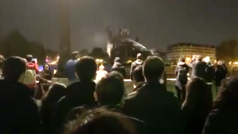 WATCH: Mourners Sing Hymns Into The Night Outside Notre Dame Cathedral
