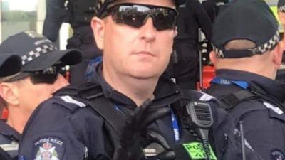 VIC Police Deny This Officer Threw A White Supremacist ‘OK’ At Climate Protest