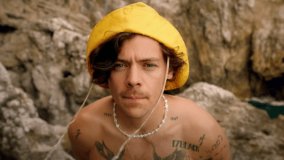Harry Styles’ New Golden Clip Is A Love Letter To Running Around And Taking Off Your Shirt