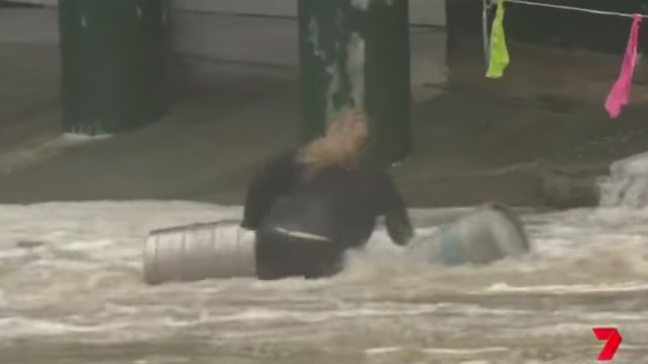 Dramatic Scenes On The Gold Coast As Woman Braves Wild Surf To Rescue Two Precious Beer Kegs