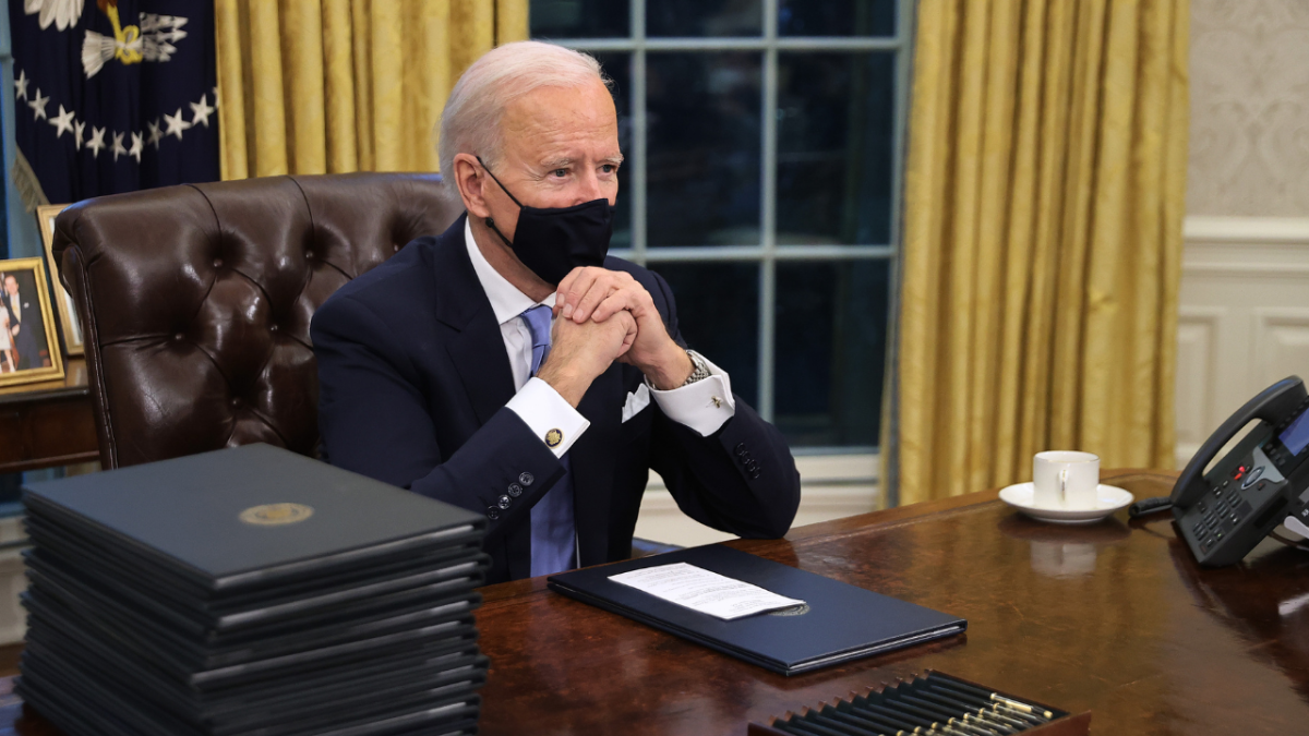 Joe Biden at his desk, sans Diet Coke button