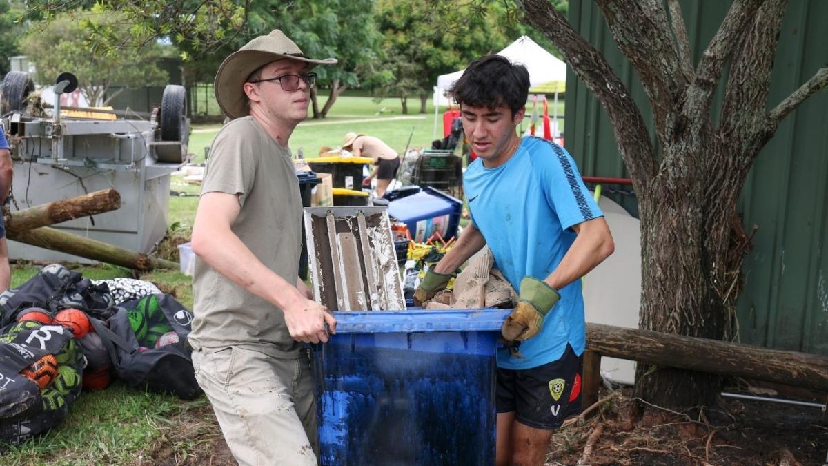 local volunteers cleaning up Brisbane after devastating floods. here's how you can help