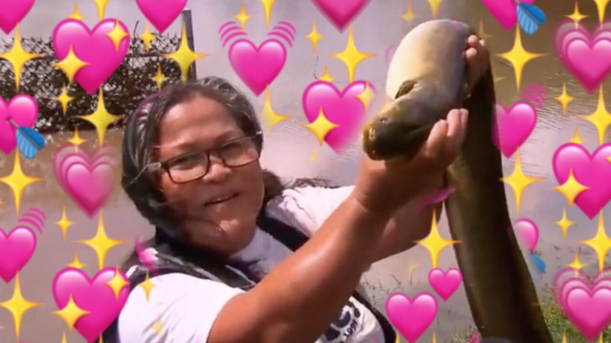 a Queensland woman holding an eel surrounded by heart emojis