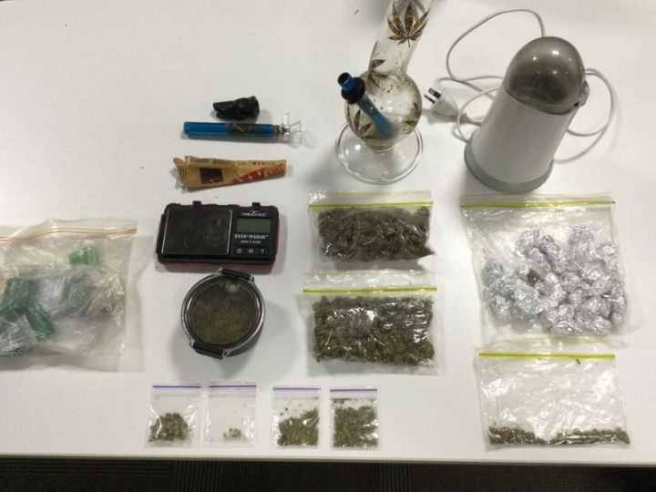 Weed, a bong and scales on a white table