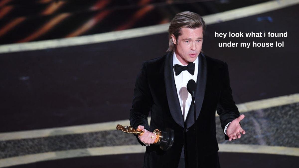 Brad Pitt holding gold Oscar award onstage