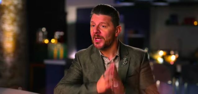 Manu Feildel on My Kitchen Rules, with his hands crossed together