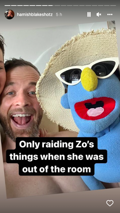 Hamish Blake holding a blue puppet wearing a hat and sunglasses with the caption: Only raiding Zo's things when she was out of the room
