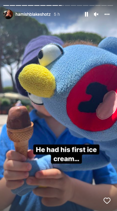 A blue puppet eating an ice cream