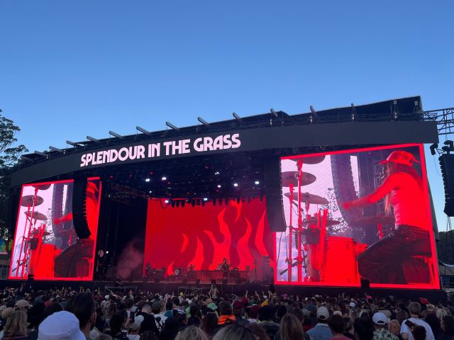 G Flip performing at Splendour In The Grass 2022 with flames on screen, drumming.