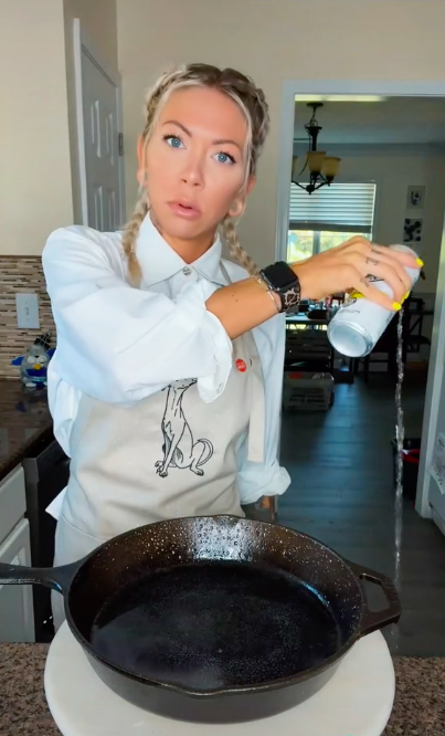 Brittnee Alexus pouring a can of lemon-flavoured White Claw onto the floor