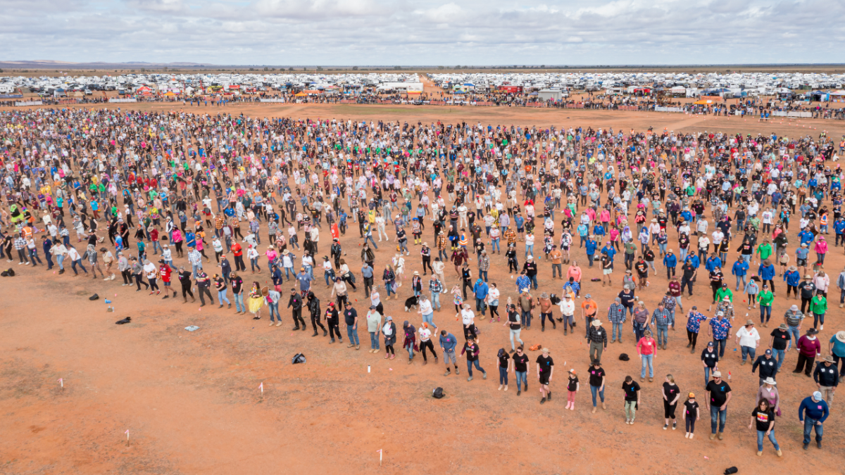 Thousands of people dancing the Nutbush at the Mundi Mundi Bash in Broken Hill, New South Wales