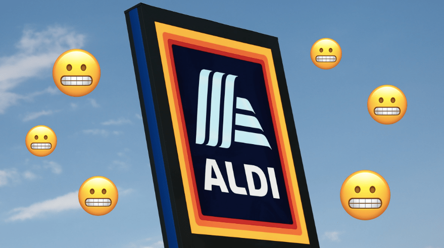 An Aldi sign with grimacing emojis around it