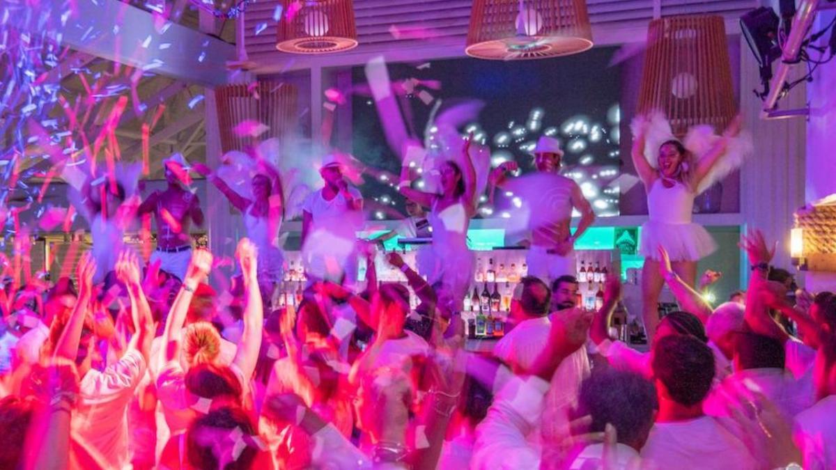 Club Med GOs / Club Med GO staff partying in a white party, doing crazy signs