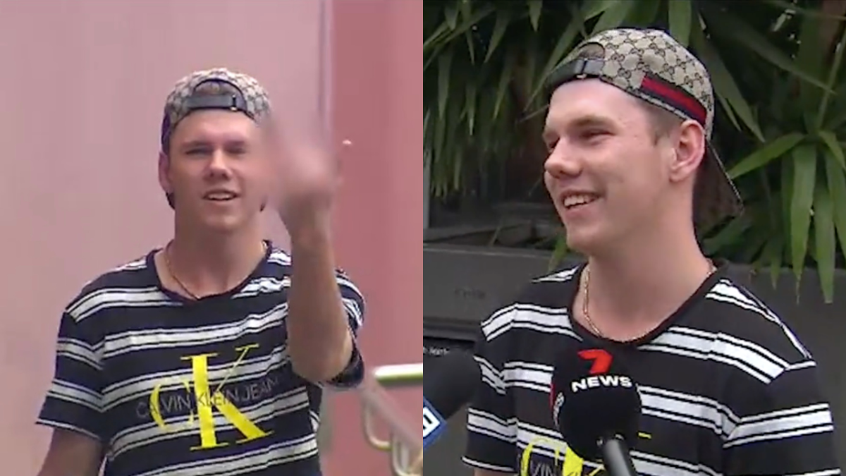 News footage of a teenager walking out of police watchhouse flipping the bird and then him smiling as he talks to reporters, wearing a striped t-shirt and a Gucci cap