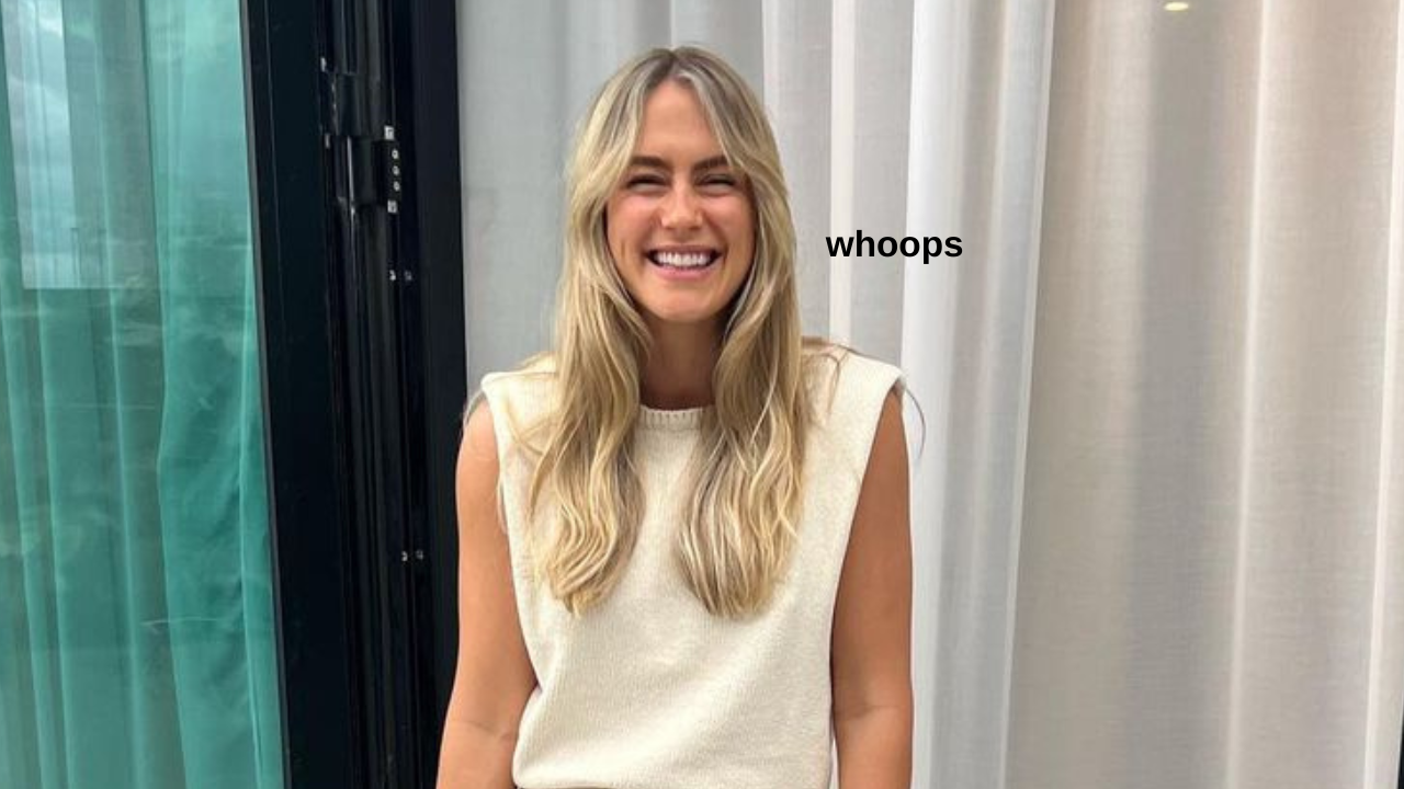Fitness influencer Steph Claire Smith smiling in a white sleeveless blouse saying "whoops"