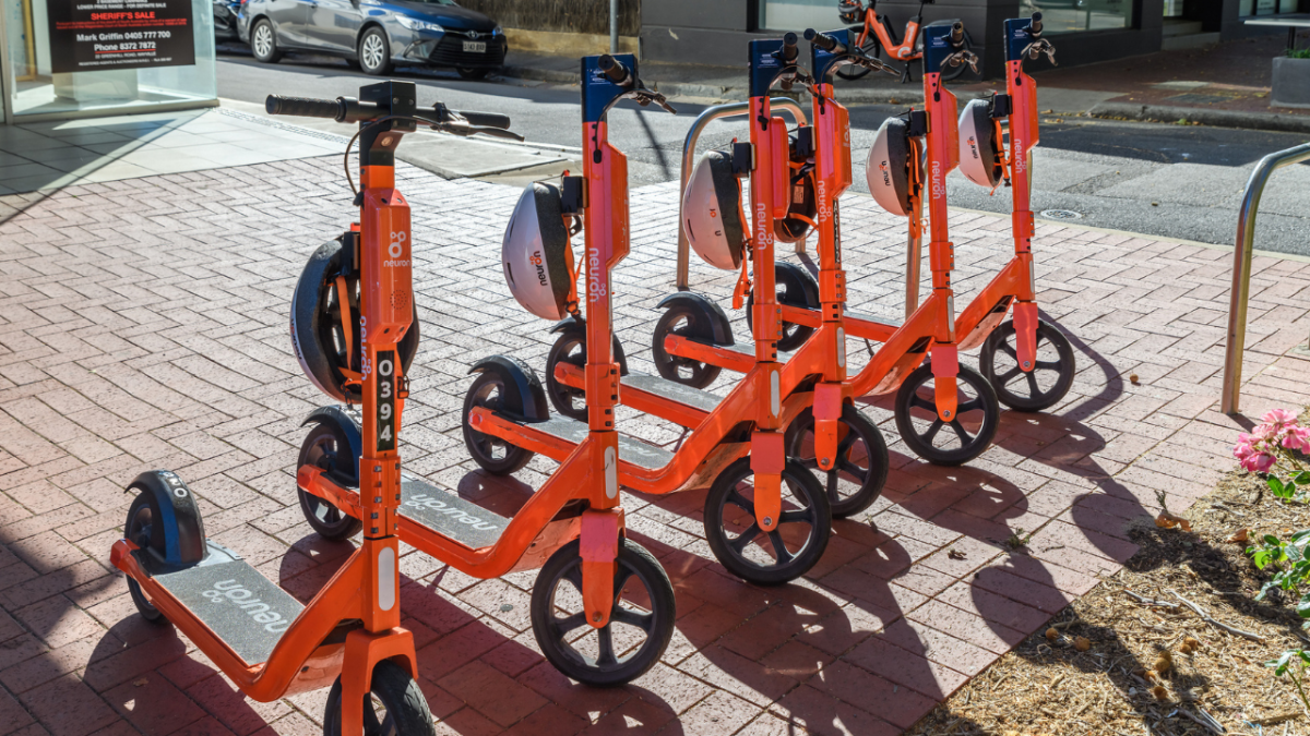 Orange Neuron E-scooters parked on Adelaide street