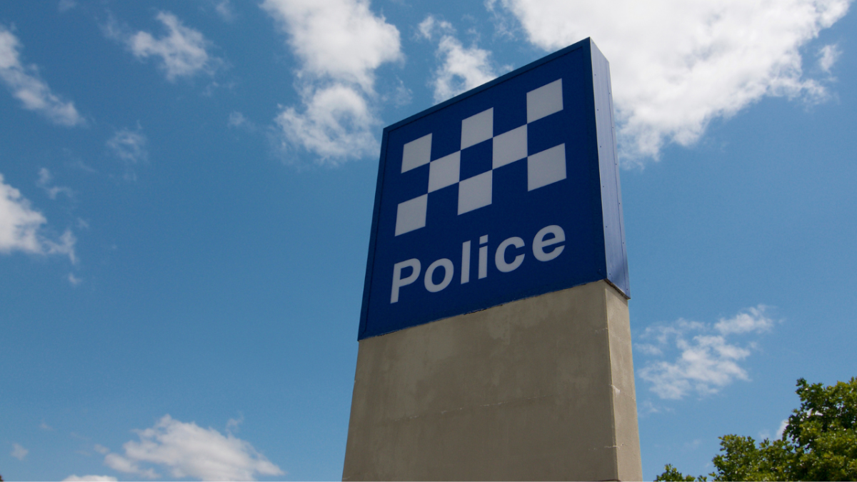 Australian Police sign against a blue sky located outside a police station in Greenslopes, Brisbane, Australia
