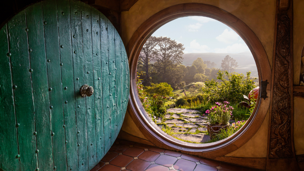 Open hobbit hole door and view from hobbit hole at Hobbiton Airbnb in New Zealand