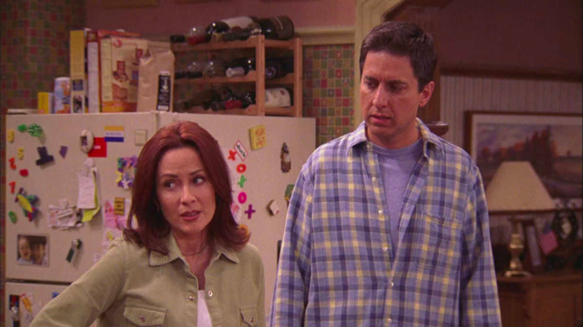 Debra and Ray Barone standing in their kitchen in sitcom Everybody Loves Raymond