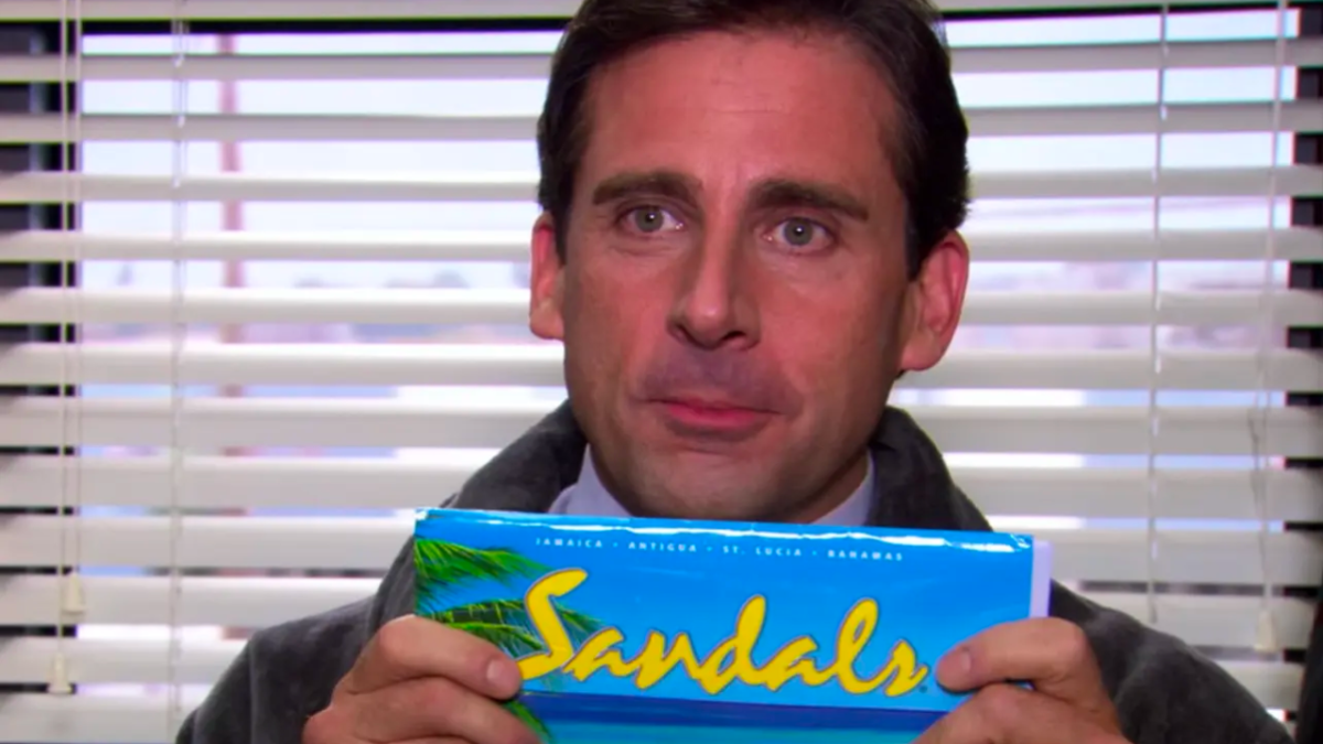 Michael Scott on The Office holding a ticket for Sandals, Jamaica.