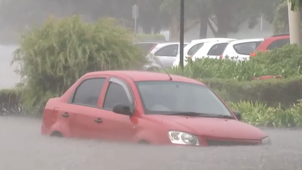 red car submerged in water as a severe storm hit sydney and the illawarra in nsw