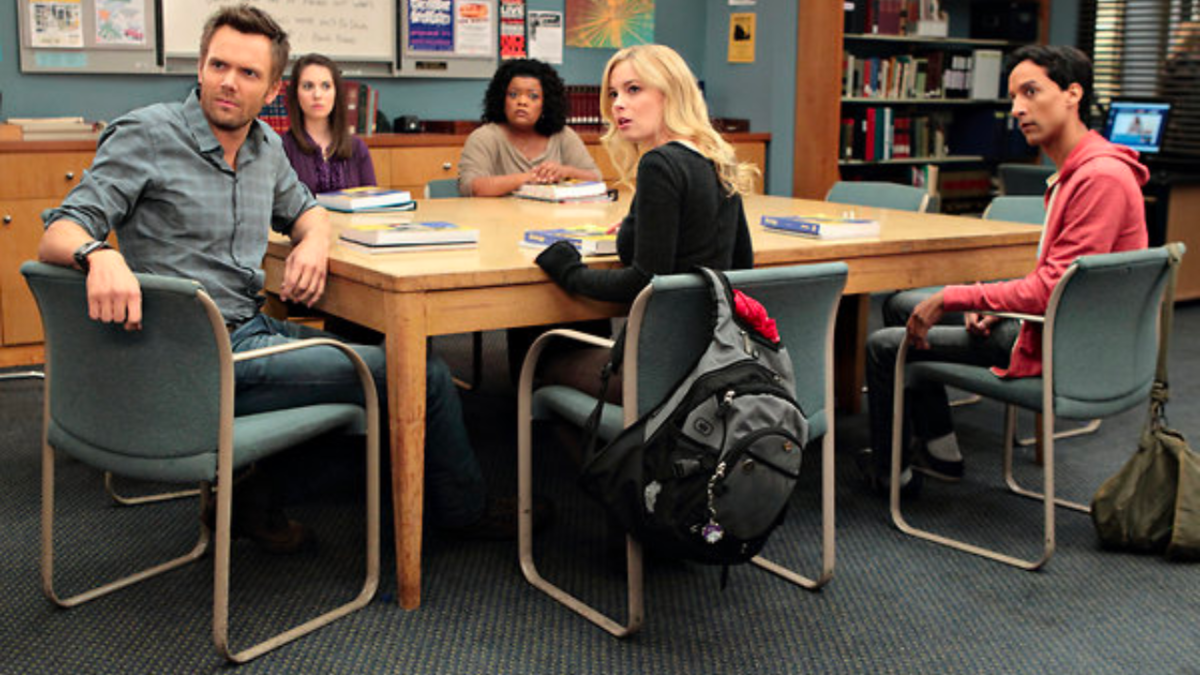 Scene from Community with characters seated around a table in class.