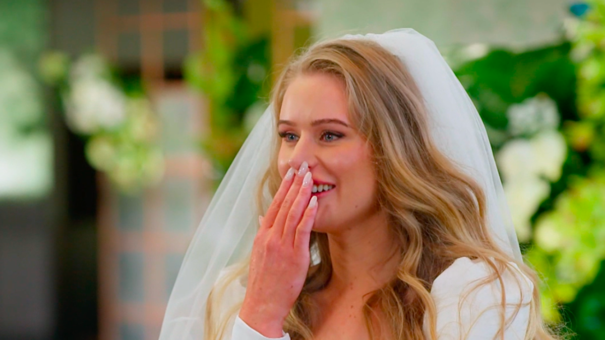 MAFS bride Tayla at the altar with her hand covering her mouth as she laughs