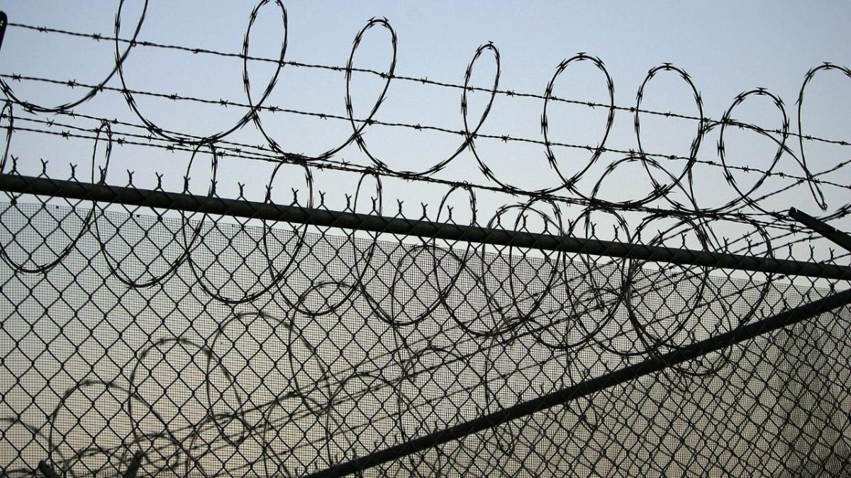 A picture of barbed wire around a jail or detention centre. The UN's torture prevention body terminated its inspection of australia after the government refused it full access to all detention centres and facilities