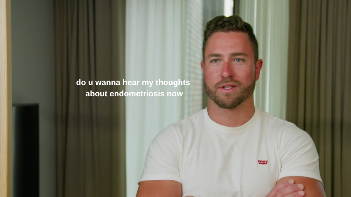 MAFS Harrison Boon standing in front of curtains wearing a white t-shirt with text on screen which reads: "do u wanna hear my thoughts about endometriosis now"