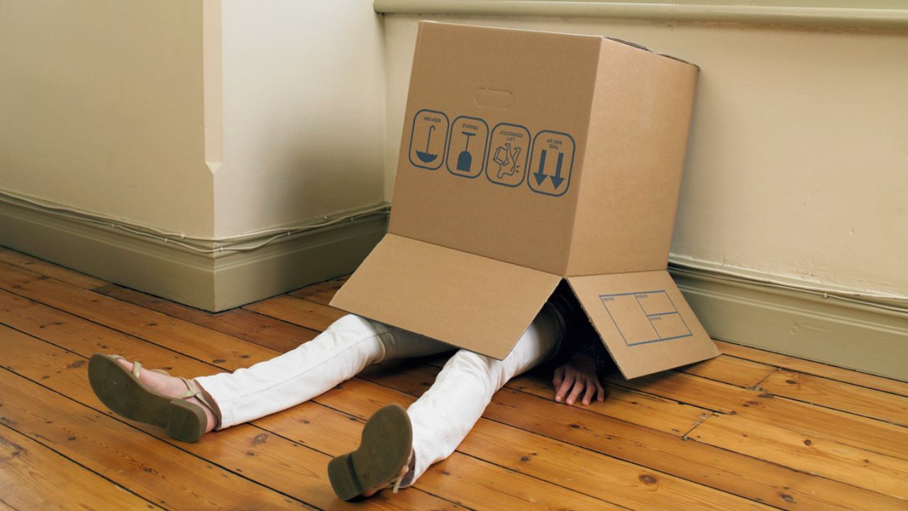 woman sitting in cardboard box. A New Affordable Rental Properties Report Has Revealed Just How Fkd The Rental Market Is RN
