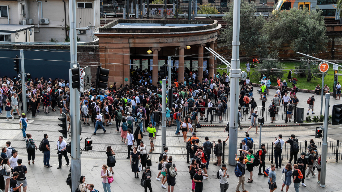 Commuters wait outside Central Station in Sydney following a rail network shutdown which caused huge Uber surge prices