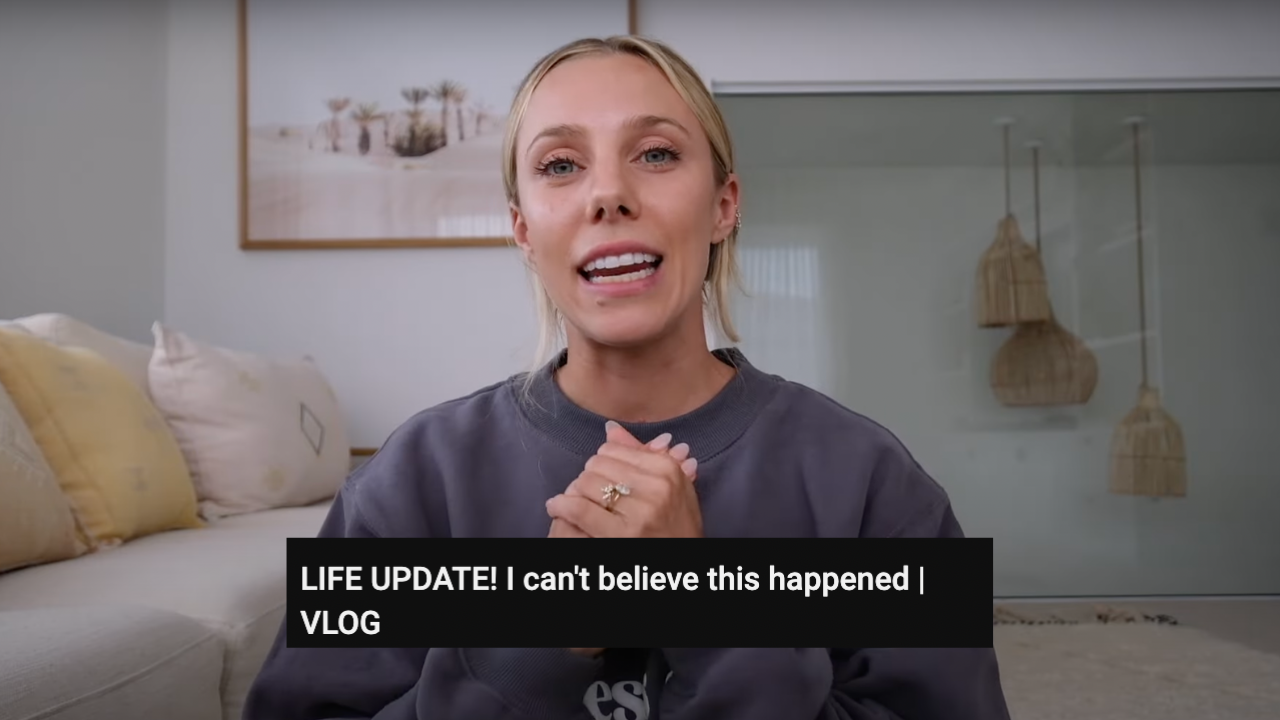 Australian influencer Sarah Stevenson or Sarah's Day wearing grey jumper in vlog with title of YouTube video overlaid which reads "LIFE UPDATE! I can't believe this happened | VLOG"