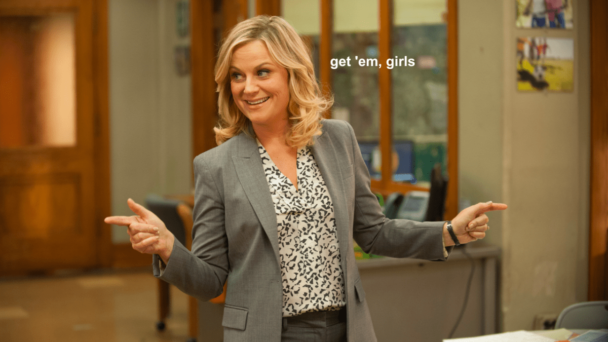 Leslie Knope in Parks & Recreation doing finger guns excitedly with white text onscreen which reads "get 'em, girls" as a gender pay gap bill has passed in Australian Parliament