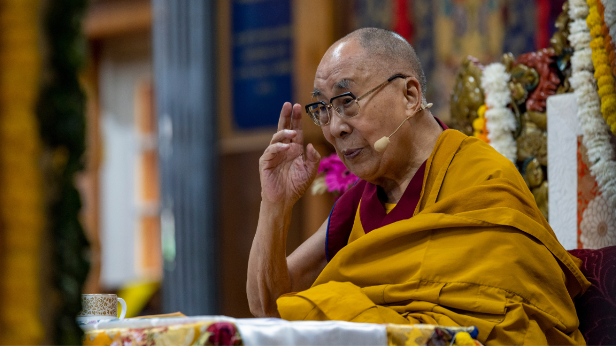 Dalai Lama gesturing as he speaks at the Tsuglakhang temple in Dharmsala, India