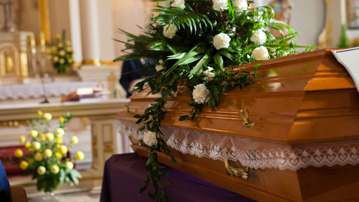 coffin with flowers on it inside church