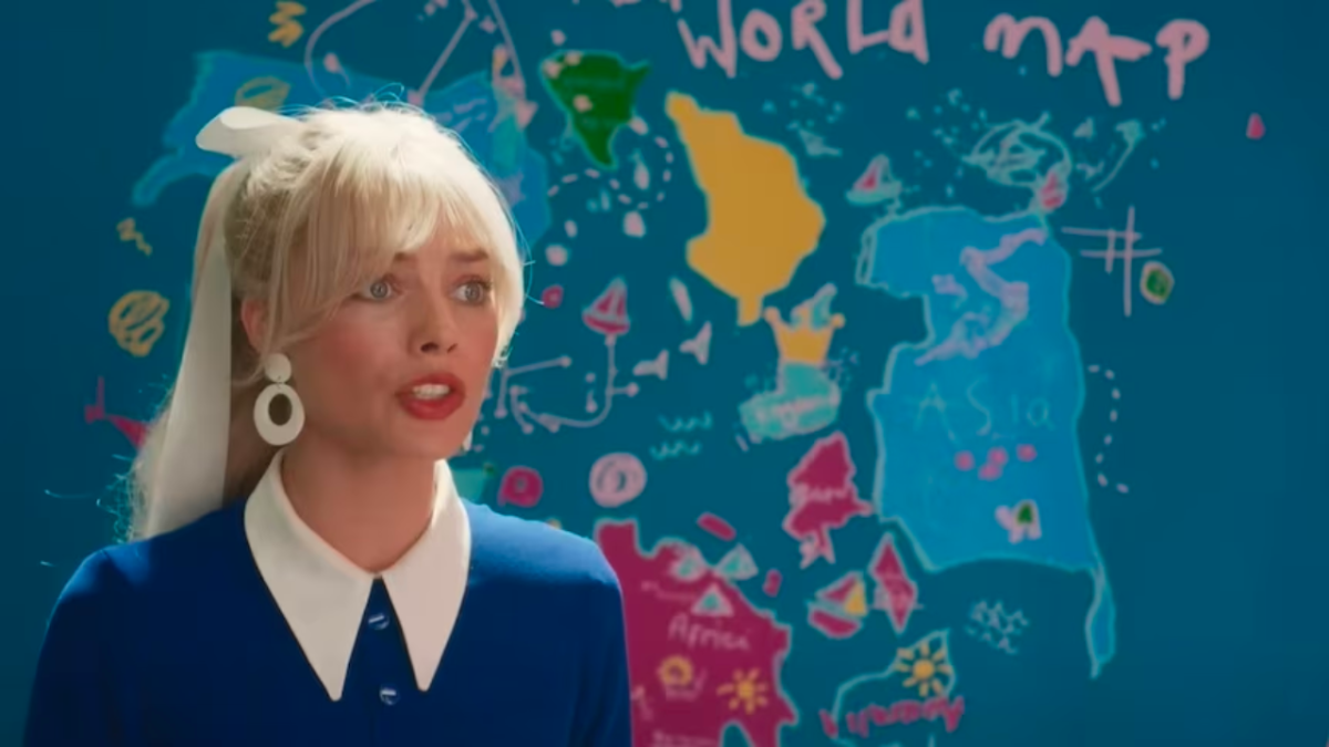 Margot Robbie in Barbie movie standing in front of "real world" map showing South China Sea and nine-dash line