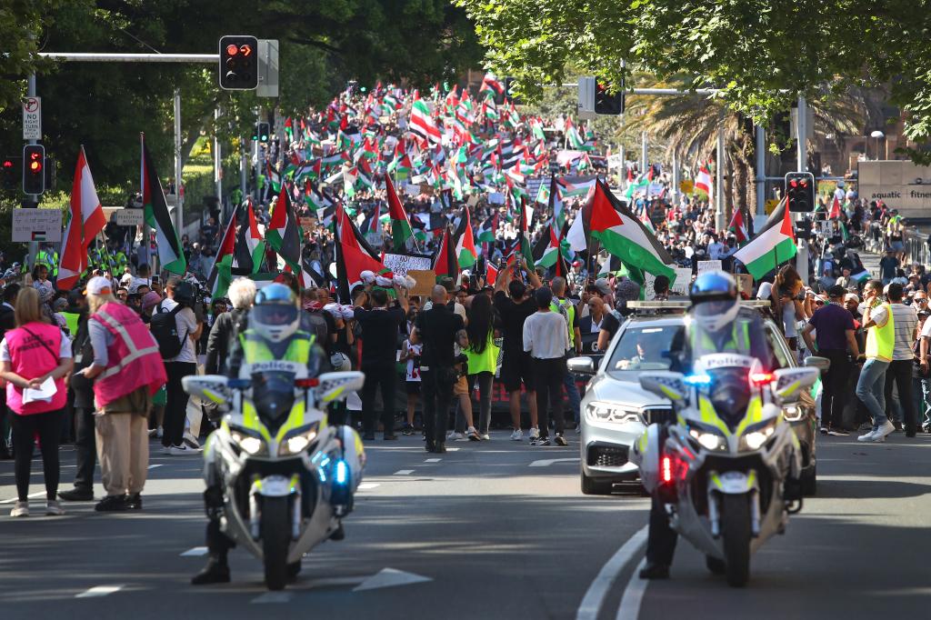 SYDNEY, AUSTRALIA - OCTOBER 29: People march along College Street during a 'Free Palestine' protest on October 29, 2023 in Sydney, Australia. On October 7, the Palestinian militant group Hamas launched the largest surprise attack from Gaza in a generation, sending thousands of missiles and an unknown number of fighters by land, who shot and kidnapped Israelis in communities near the Gaza border. The attack prompted retaliatory strikes on Gaza and a declaration of war by the Israeli prime minister. (Photo by Lisa Maree Williams/Getty Images)