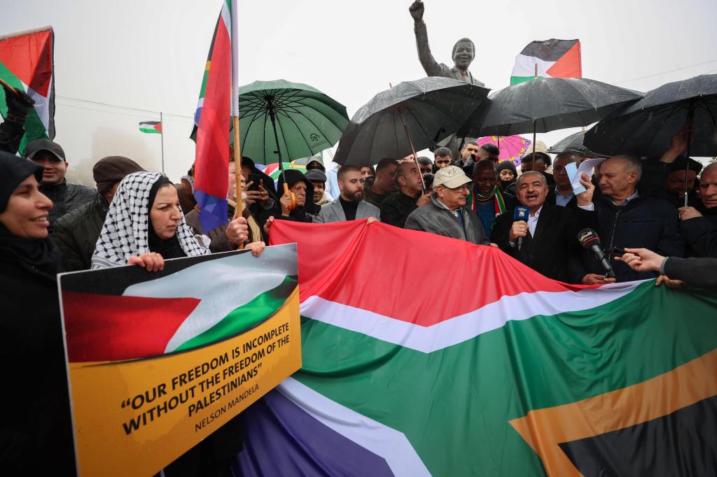 Palestinians in the West Bank carrying flags and banners to support South Africa's genocide case against Israel.