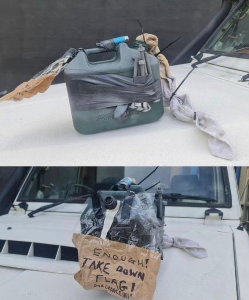 Homemade fake bomb strapped to car in South Sydney suburb Botany. The sign reads: "Enough! Take Down Flag! One Chance!