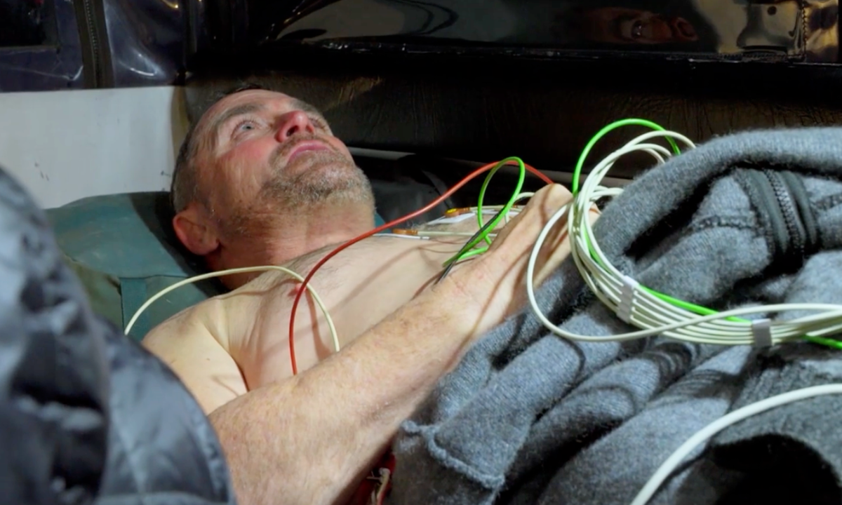 Mike on Alone Australia Season 2 lying down with heart monitoring equipment attached to his bare chest