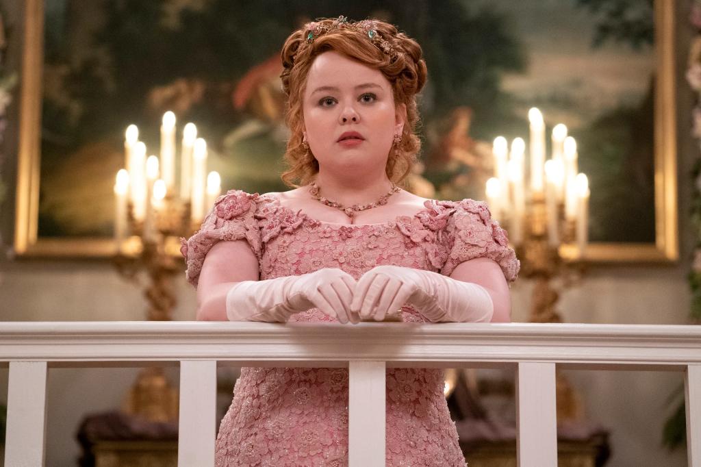 Penelope Featherington (Nichola Coughlan) dressed in a pink dress with gloves on in Netflix's Bridgerton.
