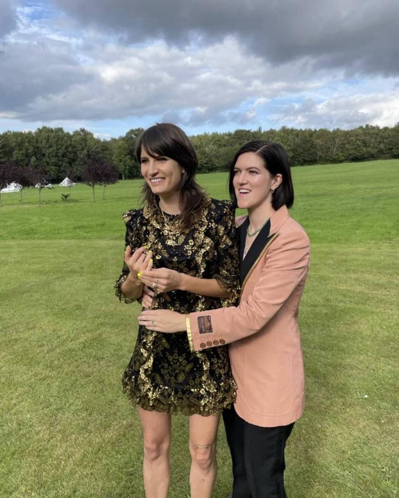 Vic Lentaigne and The XX's Romy Madley Croft hugging in a field